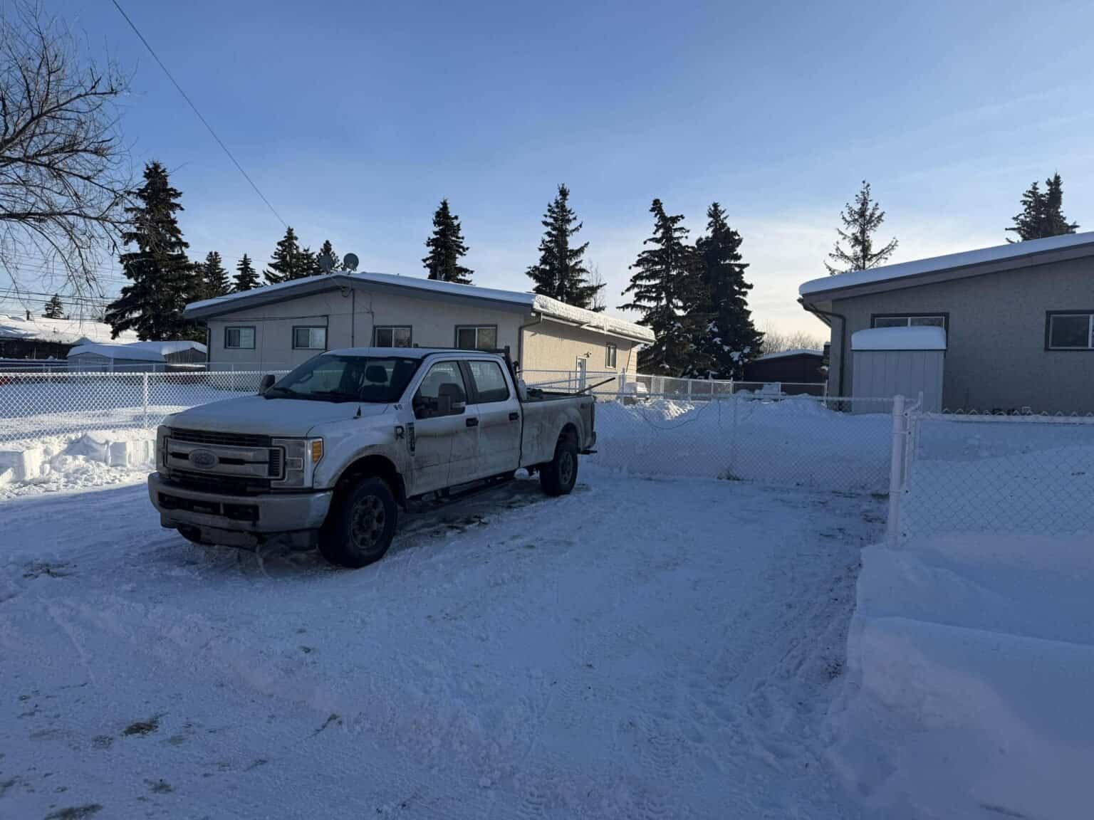 Driveway cleared of snow with Drew's truck in Grande Prairie